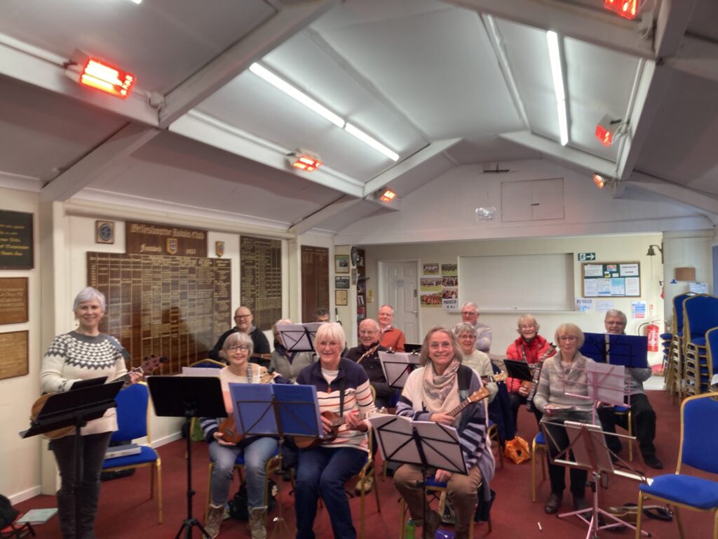 group of ukulele players sat at their music stands ready to play